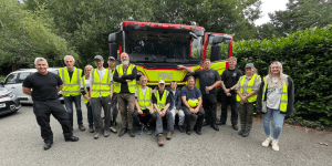 volunteer team pose in front of fire truck